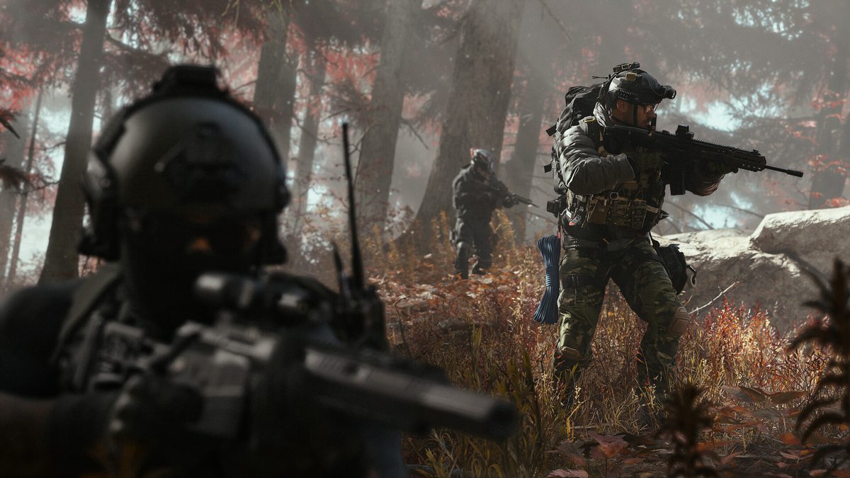Soldiers with rifles and night-vision gear moving through a forest