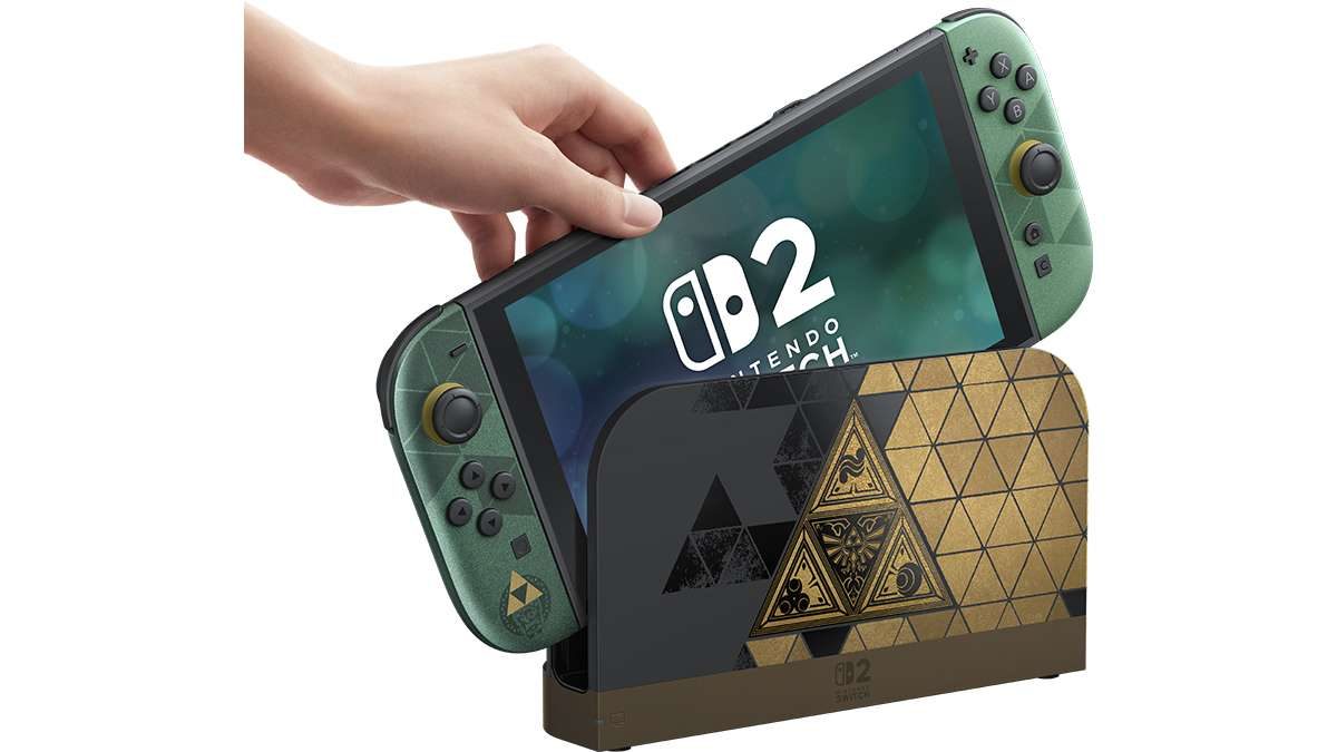 A hand placing the Zelda 40th Anniversary Edition Switch 2 into its Triforce dock