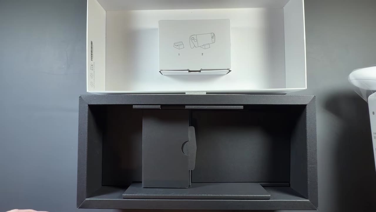 ROG Xbox Ally box opened with the white cardboard stand inside