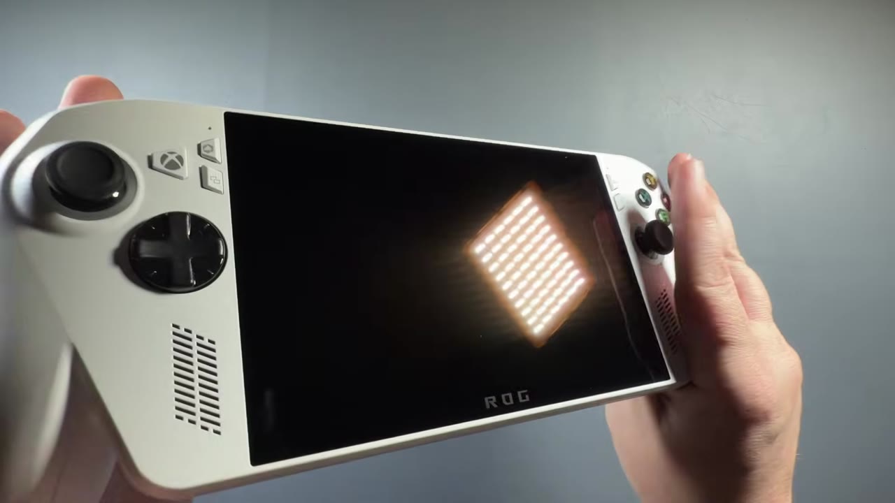 White ROG Xbox Ally held in hand, showing the 7-inch screen and Xbox-style grips